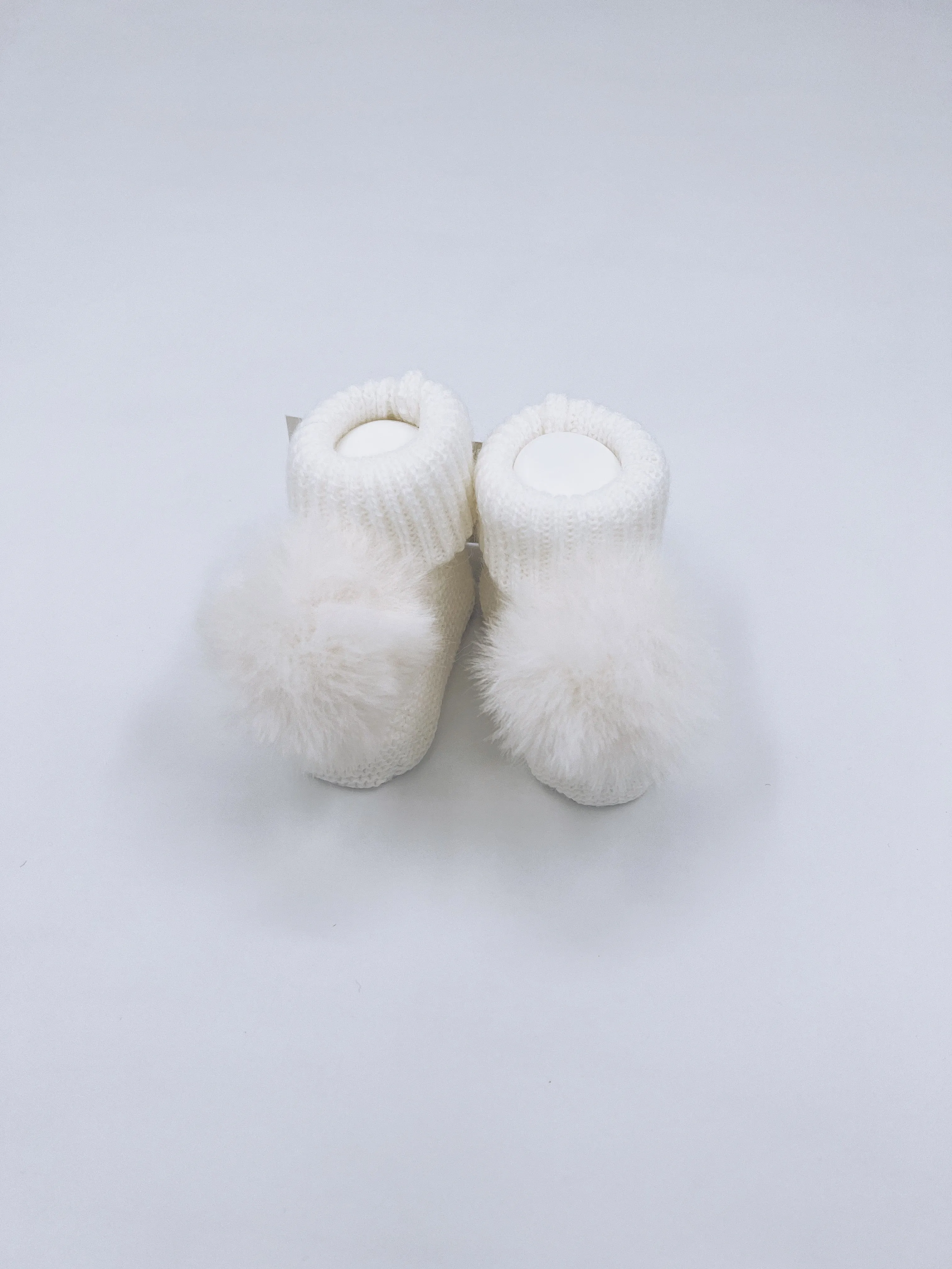 Ivory knitted Pompom booties.